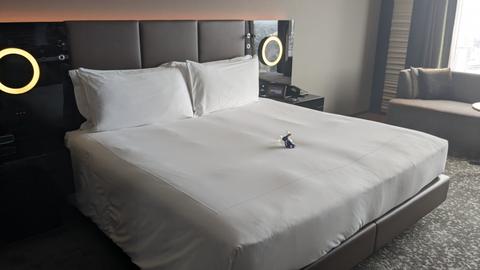 Guest room with plush bedding and sofa